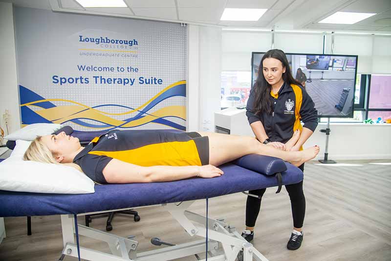 A client laying on the sports therapy table and being given a lower leg massage.